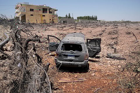 Israeli drone strike in Lebanon: A damaged car is seen at a field